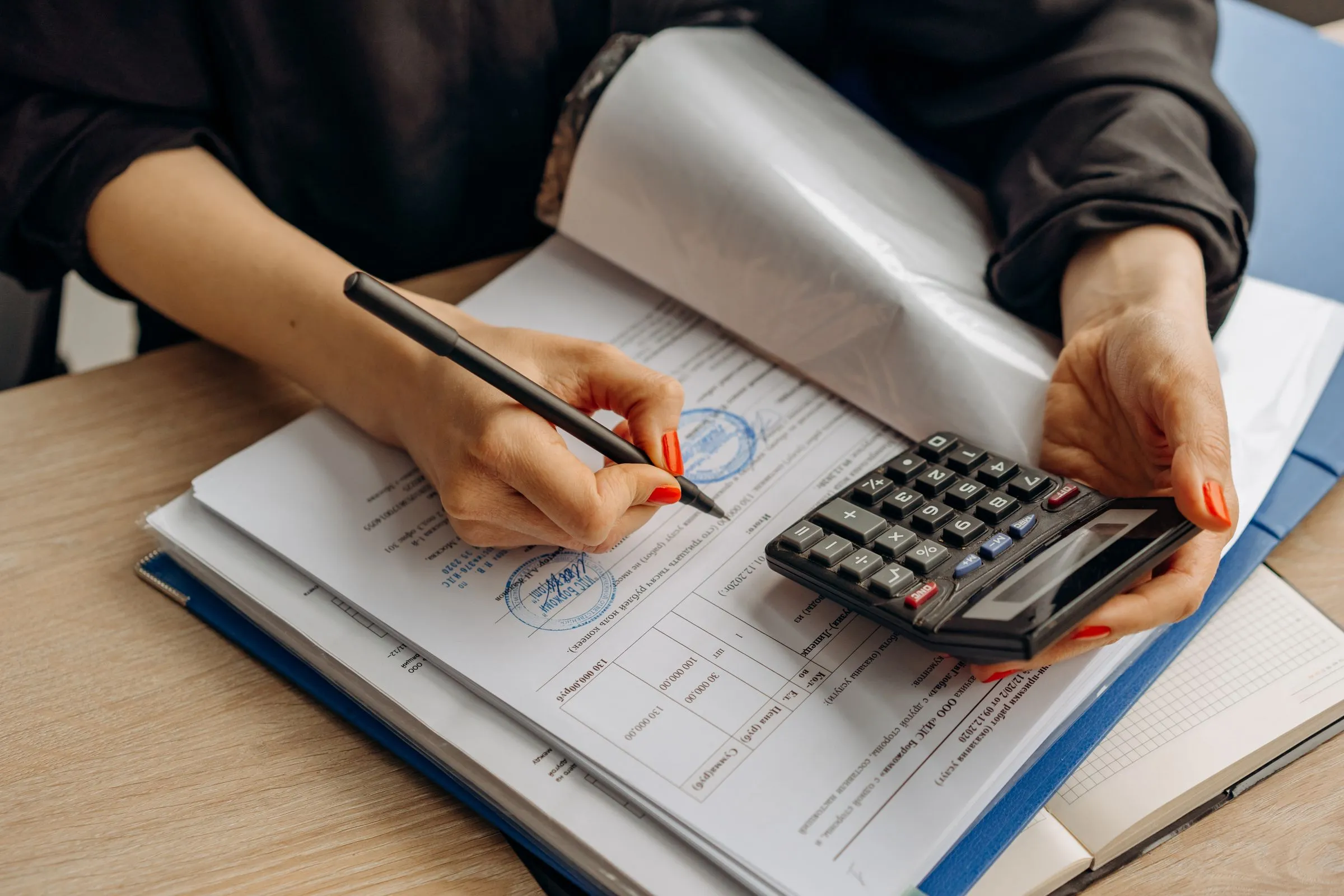 An accountant reviewing working papers with a calculator